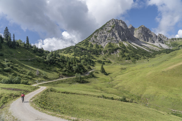 在奥地利泰洛坦海姆山谷骑山地自行车的老年妇女图片下载