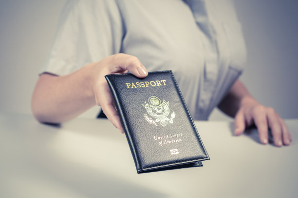 机场的出入境和护照检查。持有美国公民美国护照的女性边境管制官。概念图片下载