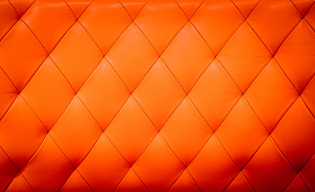 特写纹理的复古红色皮革沙发为背景图片下载