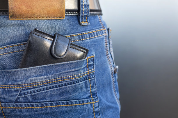 钱包在后面的牛仔裤口袋。企业生活方式的概念图片下载