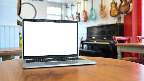 音乐屋木桌上的笔记本电脑模型。图片下载