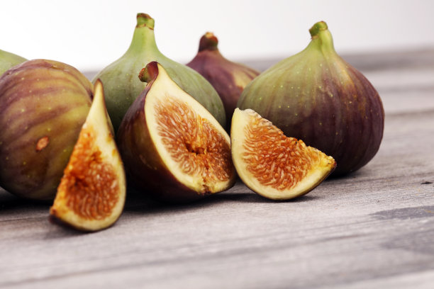新鲜的无花果。食物的照片。整个和切片无花果在乡村背景。图片下载