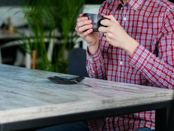 坐在白色桌子边喝咖啡的人图片下载