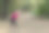 美丽的年轻苗条的女人使健身房在早晨公园。倾斜下来，明亮的运动服，白色耳机，冷静和放松气氛，伸展训练。图片下载
