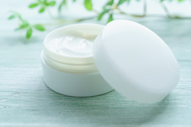 木制背景上的白色美容霜图片下载