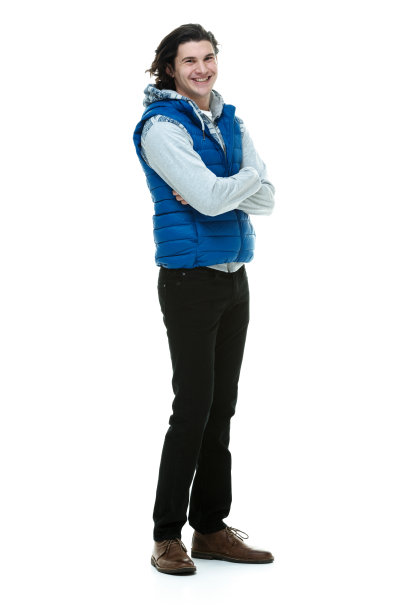 全身/一人/一人20-29岁英俊的人/长发白人男性站在白色背景前，穿着背心/连帽夹克/衬衫/运动衫/牛仔裤，面带微笑/快乐/愉快/自信图片下载