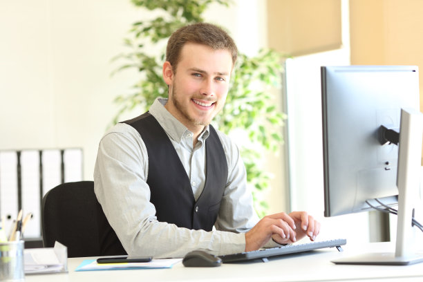 快乐的执行官在办公室看着相机摆姿势图片下载