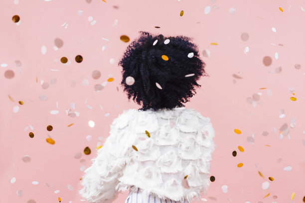 一个穿着白衣的女人的背影，五彩纸屑飘落图片下载