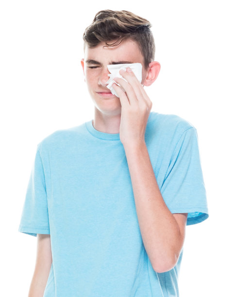 一个男人/一个人/一个十几岁的男孩/腰围12-13岁英俊的人白人男性/年轻男子男孩/十几岁的男孩在白人背景和拿着面巾纸图片下载