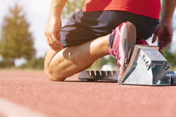 用起跑器在跑道上开始跑步的运动员。图片下载