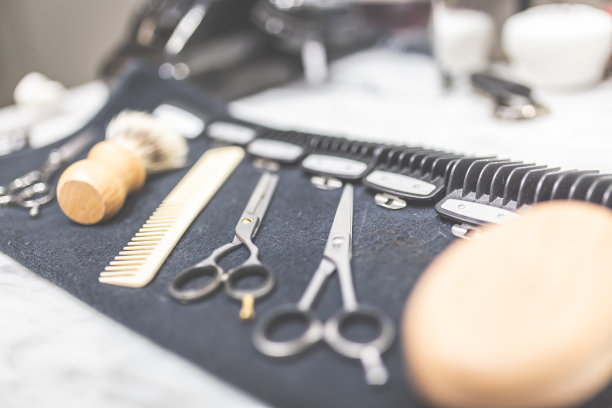 桌上的毛巾上放着剃须和理发设备。图片下载