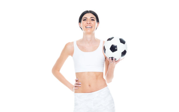 一个人/正面视图/腰部以上的20-29岁的成年人美丽/高个子/长发高加索年轻女性/女足球运动员在白色背景前穿着运动胸罩/弹力纤维/打底裤谁是微笑/快乐/愉快图片下载