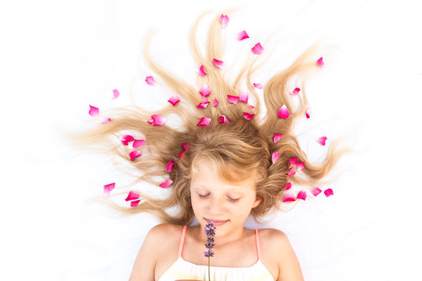 迷人微笑的幼儿用花卉装饰的发型复制空间图片下载