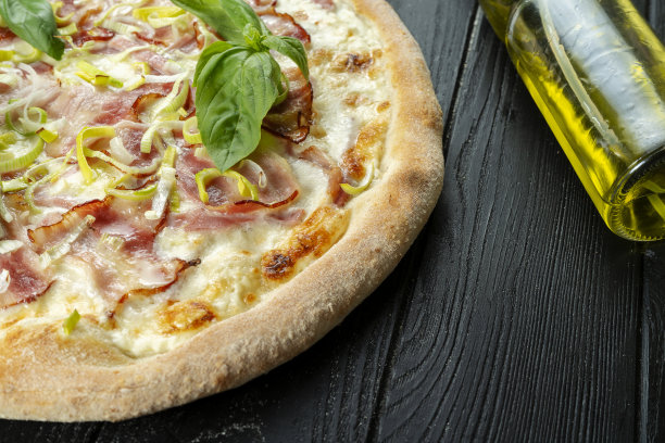 自制的新鲜干酪沙司披萨配白培根酱，放在有拷贝空间的黑木头上。俯视图食物照片。平的。意大利菜。图片下载