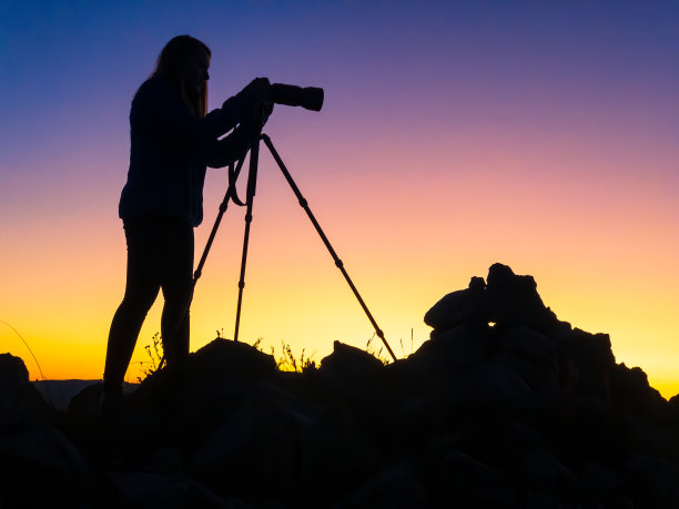 女摄影师剪影日落山顶图片下载