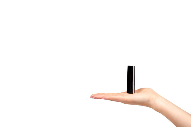 手用红色口红在黑色管，美容和护理。图片下载