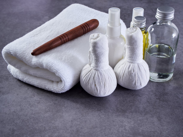 美丽的spa组成与瓜沙木，草药敷球，椰子油，瓜沙泰国草药油在灰色大理石背景。图片下载