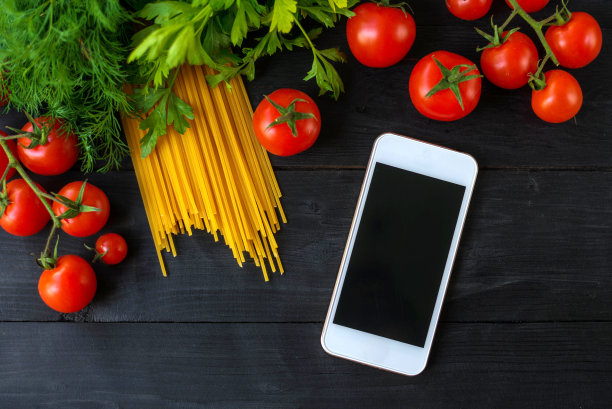 木桌上放着意大利面和圣女果。图片下载