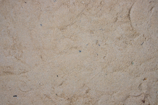 黄色的沙滩。海滨沙滩沙滩纹理。海岸俯视图照片。海边自然背景图片下载