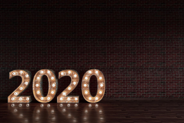 黑色砖墙上的2020灯泡标识图片下载