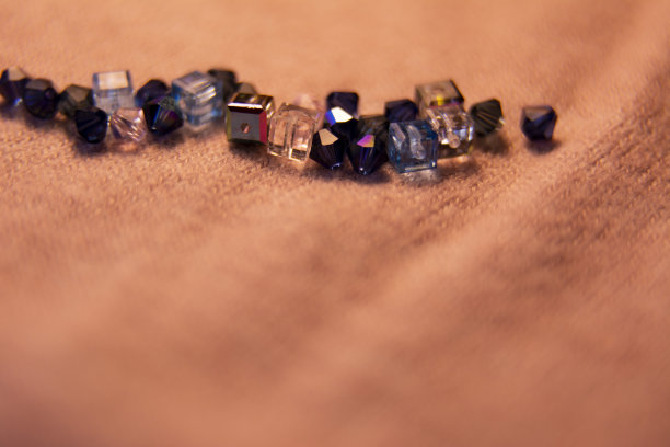 彩色的玻璃珠和水晶。各种形状和颜色，使一个珠子项链或一串珠子为妇女。模糊的照片。图片下载