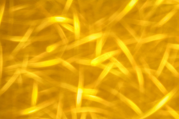 抽象闪光金色发光闪闪发光的背景。节日金色包装纸质地。圣诞节日的季节性壁纸装饰。问候和婚礼邀请卡设计模板图片下载