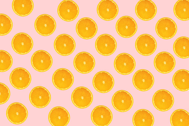 橙色的切片在粉红色的背景上。背景与模式概念图片下载