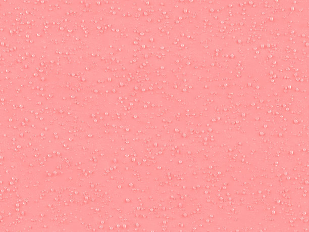 粉红色纹理表面上的水滴图片下载