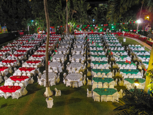 餐厅里铺着红白绿桌布的一排排桌子恭候客人图片下载