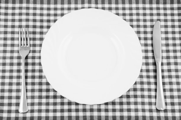 桌布上的白色盘子，叉子和刀的俯视图图片下载