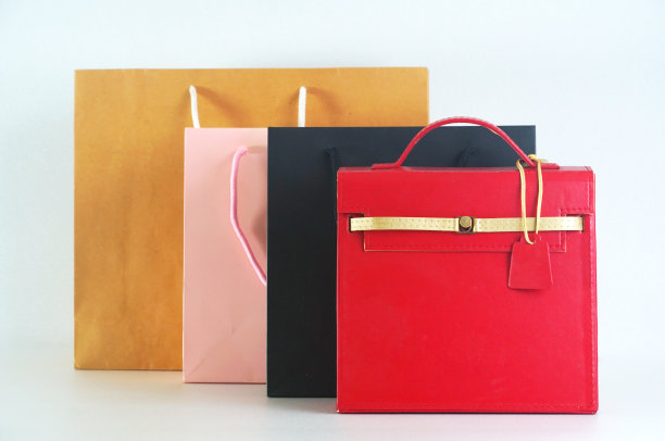 红色真皮女式手袋配群购物袋，消费理念。图片下载