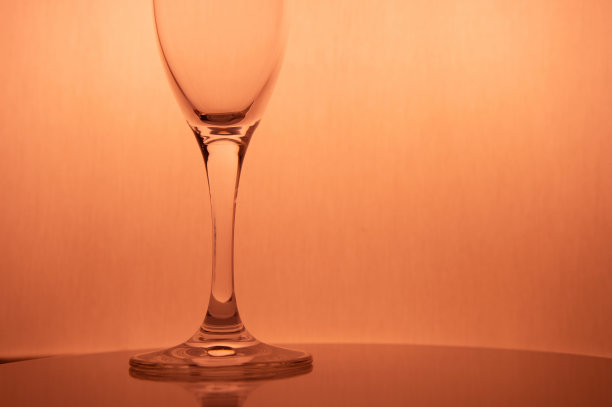 部分香槟酒杯置于浪漫的暖粉色背景上，适合聚会或庆祝活动图片下载