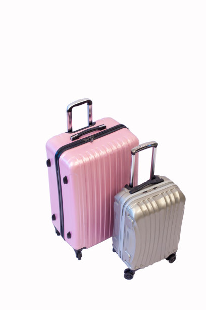 粉色和灰色的行李手推车袋侧面孤立的白色背景，紧凑的塑料旅行袋与剪切路径。图片下载