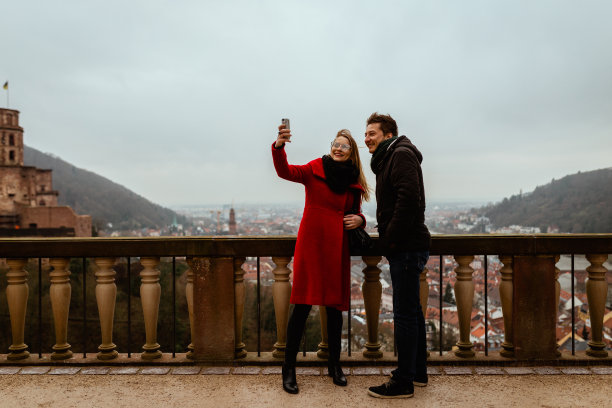 在海德堡的冬日里，年轻人用手机拍照图片下载