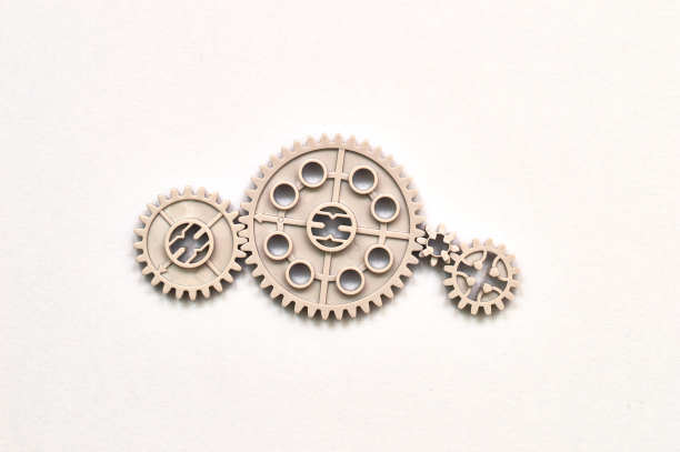 塑料灰色传动玩具齿轮和车轮模拟小组的工作论文为背景图片下载