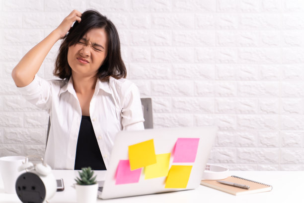 一个女人在办公室里挠头图片下载