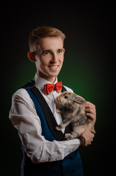 一个年轻的魔术师拿着一顶有兔子的帽子图片下载