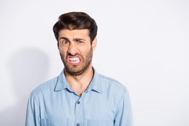 啊!令人惊异的混血儿的照片，他看起来厌恶变质的食物，可怕的气味穿休闲牛仔衬衫孤立的白色背景图片下载