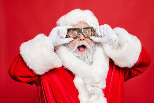 特写照片印象深刻有趣的圣诞老人触摸他的旅行涡轮眼镜看到冬季销售折扣戴白手套帽子隔离在红色背景图片下载