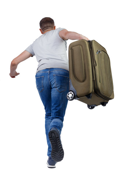 后视图行走的人与手提箱。图片下载