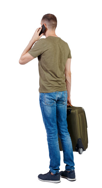 后视图的商人与手提箱交谈的电话。图片下载