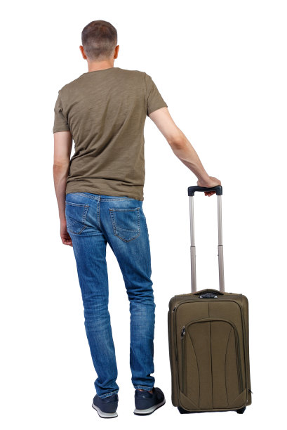 带手提箱的男人的后视图。图片下载