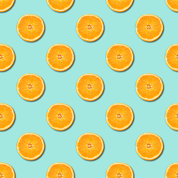 橙黄色切块的无缝图案，在新薄荷绿色的背景上。最少,平。图片下载