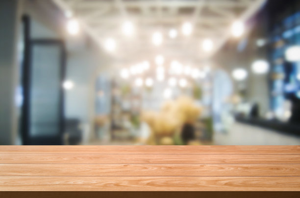 木质桌子在现代餐厅模糊的背景。图片下载