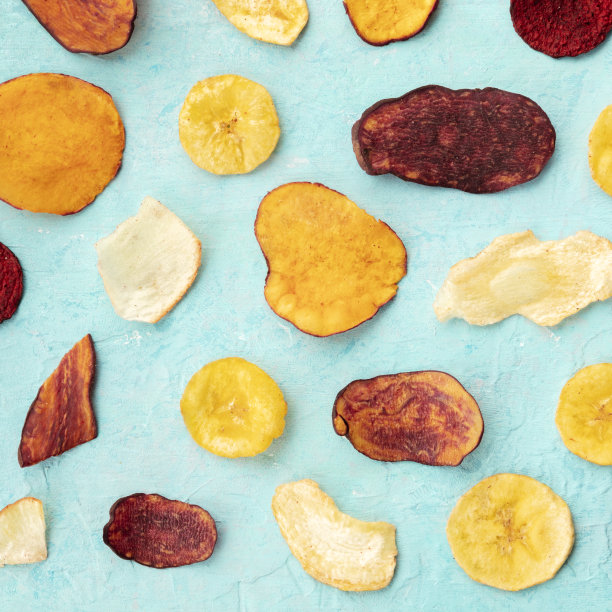 干果和蔬菜片，上方方形拍摄。健康的素食零食，有机食品平铺图案在一个蓝色的背景图片下载