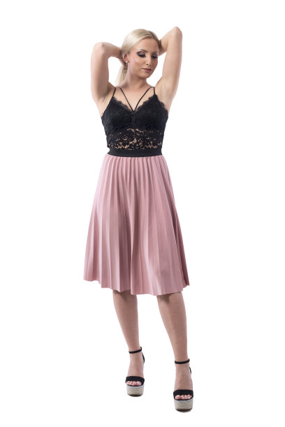 优雅年轻的金发女子在晚装与手在头发向下看持有发髻。图片下载