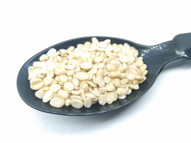 一张黑色勺子上裂开的黑扁豆的照片图片下载