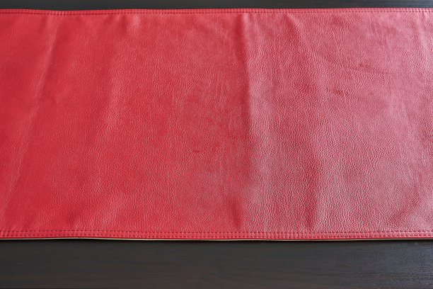 红色皮革桌布上的黑色木桌，从上面看图片下载