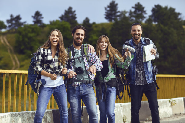 年轻人背着背包从后面站在森林里。图片下载