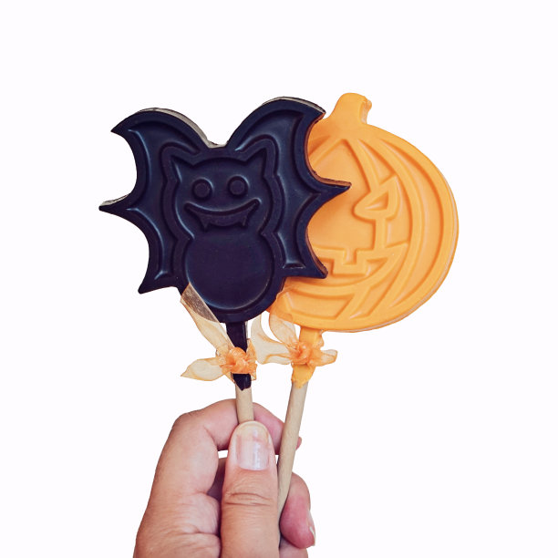 巧克力棒棒糖形状的南瓜和蝙蝠孤立在白色图片下载